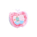 A transparent apple-shaped container, filled with pink paper soap, featuring a cactus sticker, on a plain background.