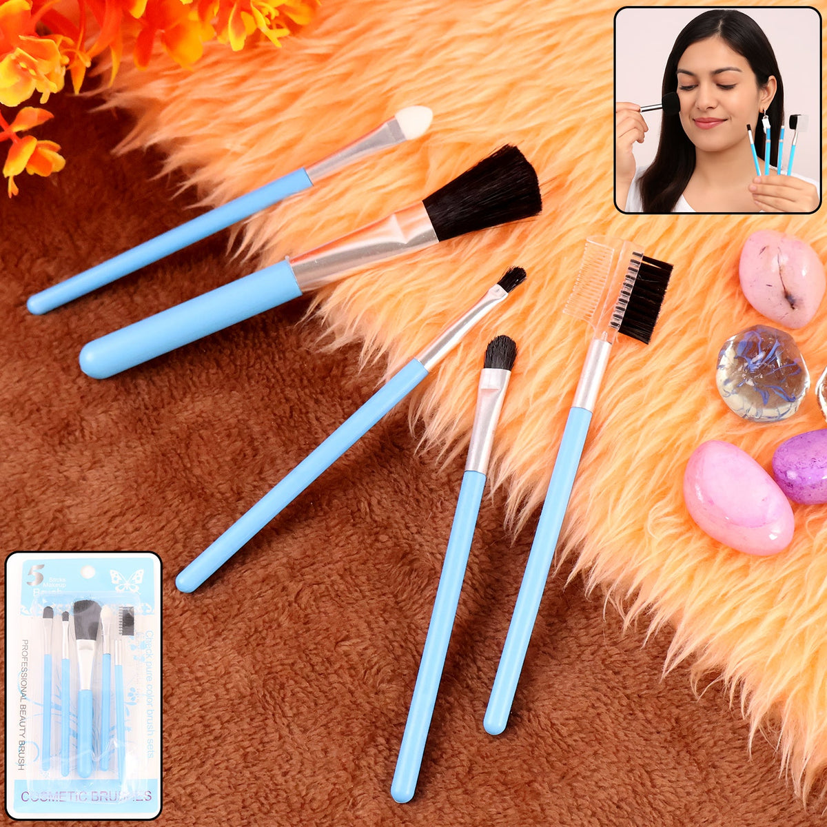 Five light blue makeup brushes are arranged on an orange furry surface, with a small inset of a woman using a brush