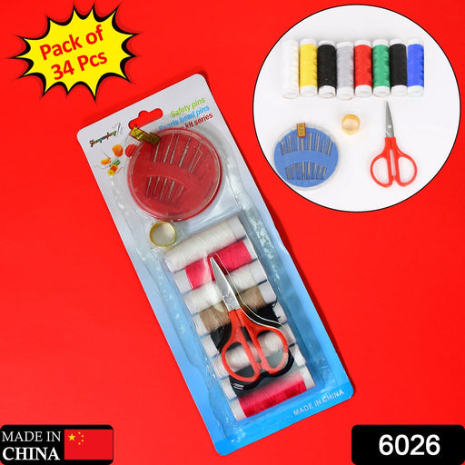 A packaged sewing kit with thread, needles, and scissors, displayed on a vibrant red background.