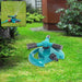 A teal and black garden sprinkler on a lawn with a smaller inset image of it in use.
