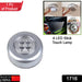 Wireless touch lamp illuminating kitchen cabinets for convenience.
