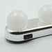 A close-up of the white LED vanity light shows two round bulbs and a black on/off switch on the chrome base.