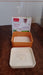 Square Paneer Maker and its packaging, showcasing the product clearly.