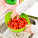 A Quickslice rice washing bowl with a thick drain basket and handle, perfect for kitchen use.