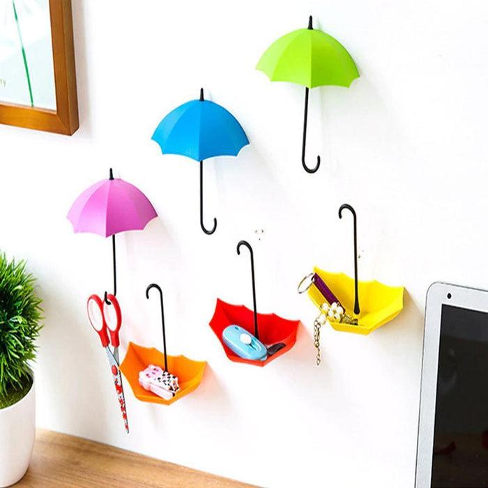 Colourful umbrella key holder mounted on a white wall, showcasing its vibrant design.