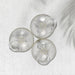 Three transparent suction cup hooks are arranged on a white textured surface with a subtle shadow.