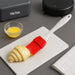 Silicone spatula and pastry brush in use for intricate cake decoration.