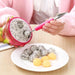 A person uses a pink-handled tool to scoop fruit from a halved dragon fruit, with dragon fruit and melon balls on a white