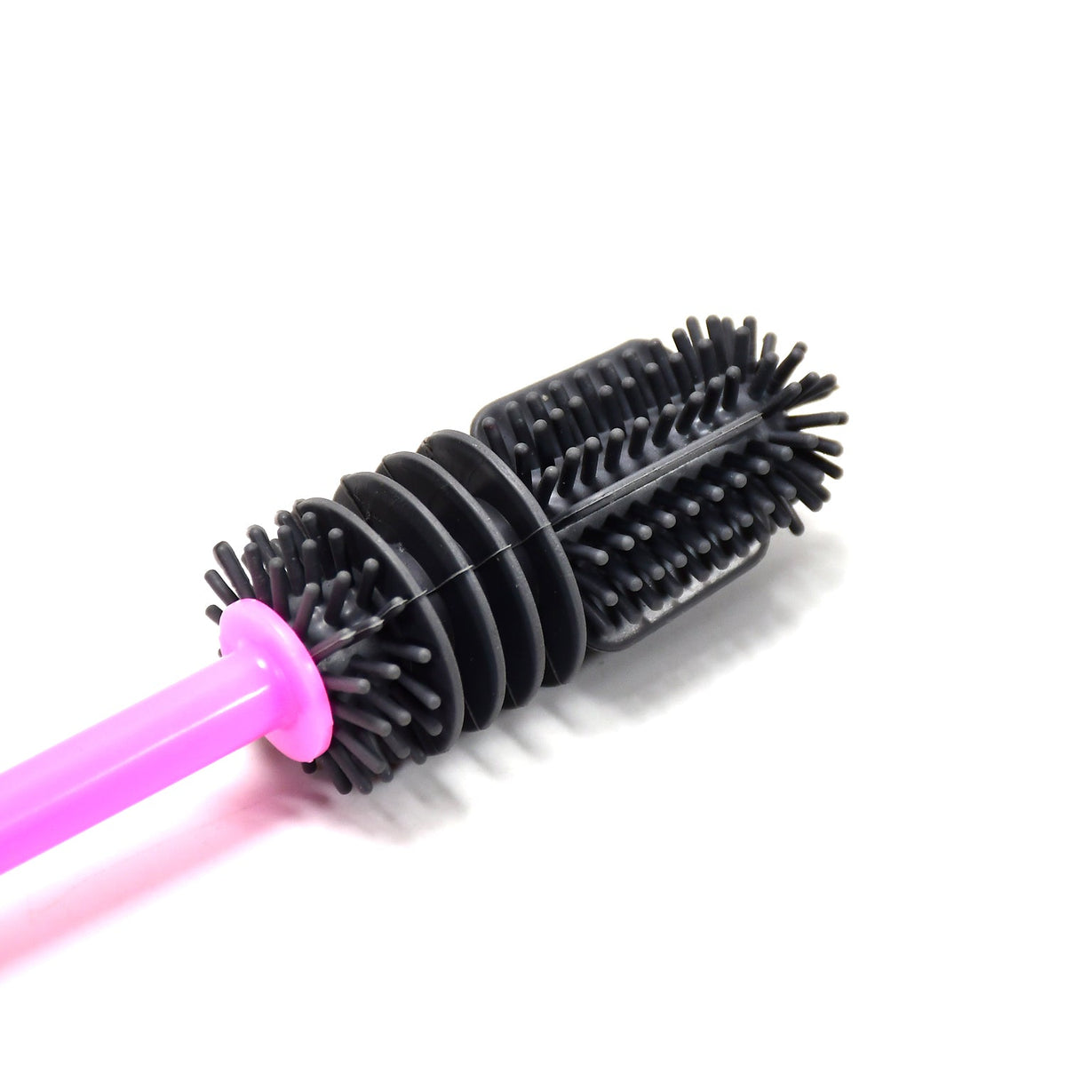 A close-up of the black silicone brush head with its textured bristles and ribbed design.