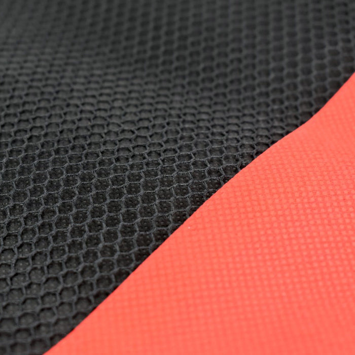 Close-up of the black mesh and red fabric textures of the laptop sleeve.