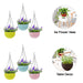 Hanging flower pots displayed outdoors on a fence, perfect for a garden decor combo.