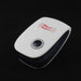 White and black pest repeller with a grey button on a dark background, viewed from an angle.