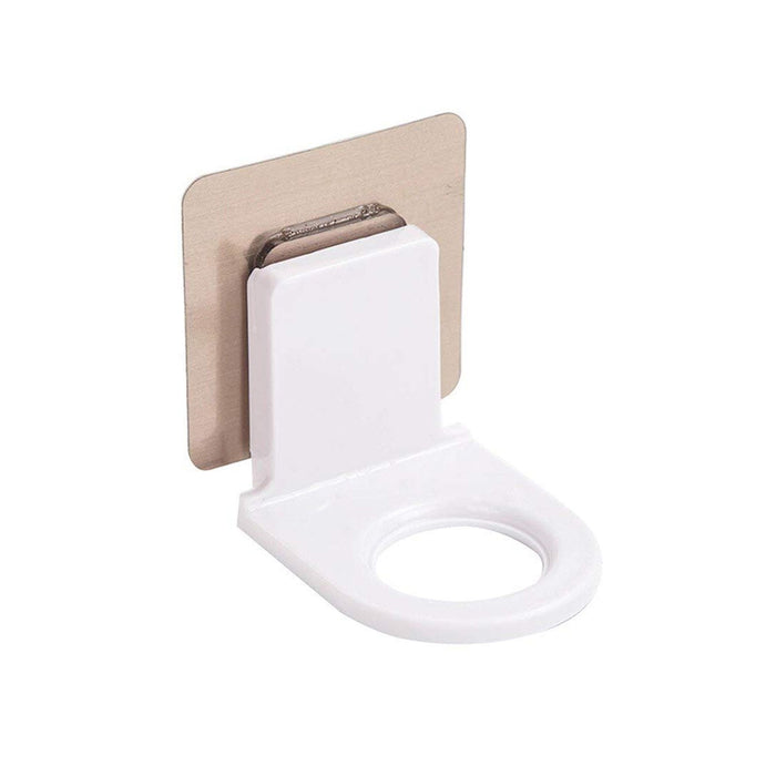 A white plastic wall-mounted bottle holder with a metallic adhesive backing shown from a slight angle.