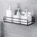 Stainless steel wall mount bathroom shelf holding toiletries.