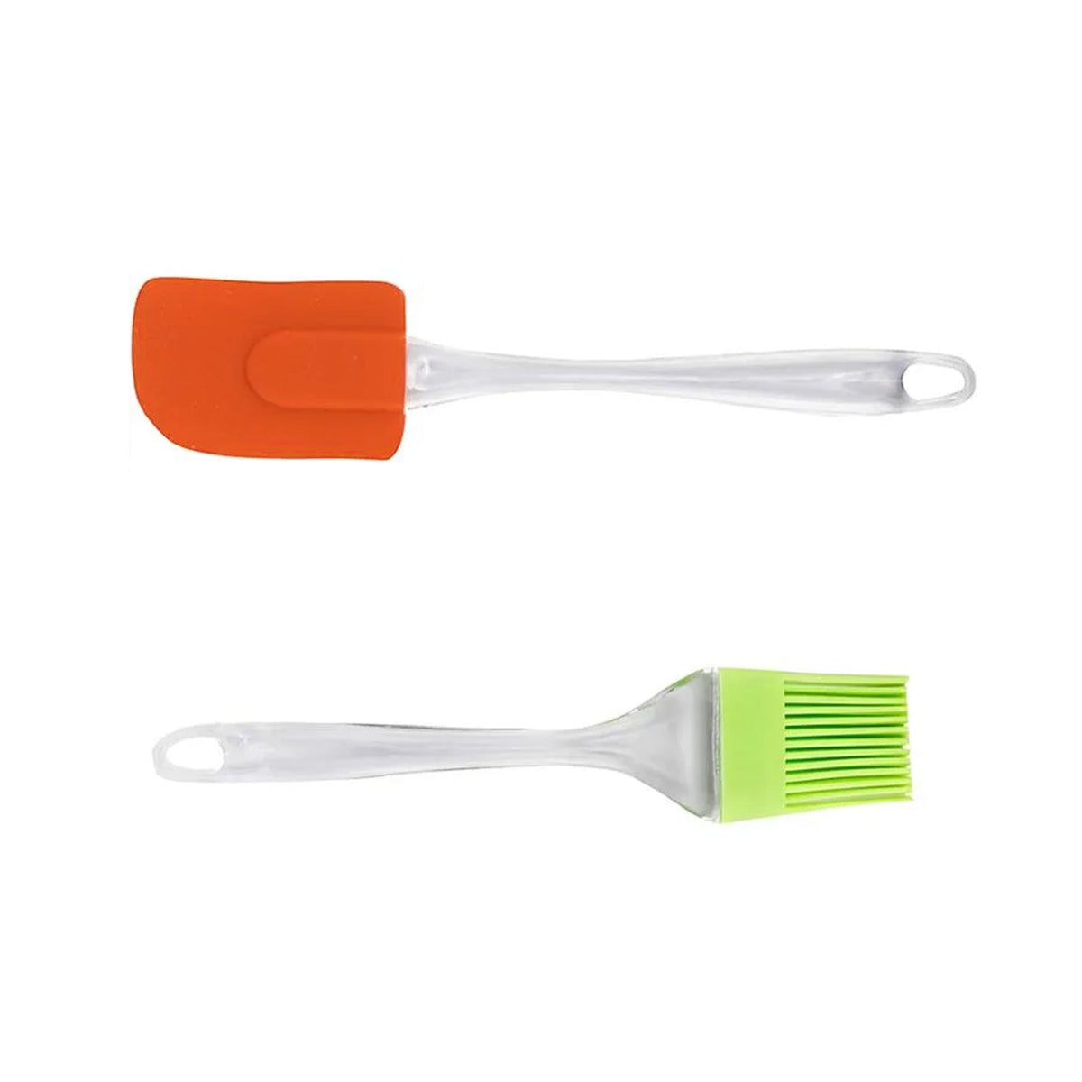 An orange silicone spatula and a green silicone basting brush with clear handles are arranged separately on a white