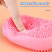 Two silicone body scrubbers, pink and blue, demonstrating color options.