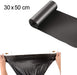 A roll of black garbage bags unrolling, with a pair of hands stretching a bag below, showing 30x50 cm dimensions.
