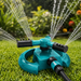 A teal and black rotating garden sprinkler waters a lush green lawn with multiple streams.