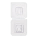Adhesive wall hooks holding various kitchen utensils, showcasing their versatile use.