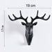 Stylish deer head hook in grey, functioning as a decorative hanger for a hat.