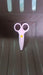 A child happily using the child-safe plastic scissors for an art project.