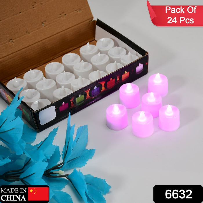 A cardboard box containing white LED tealights, with several pink glowing tealights and blue leaves beside it.