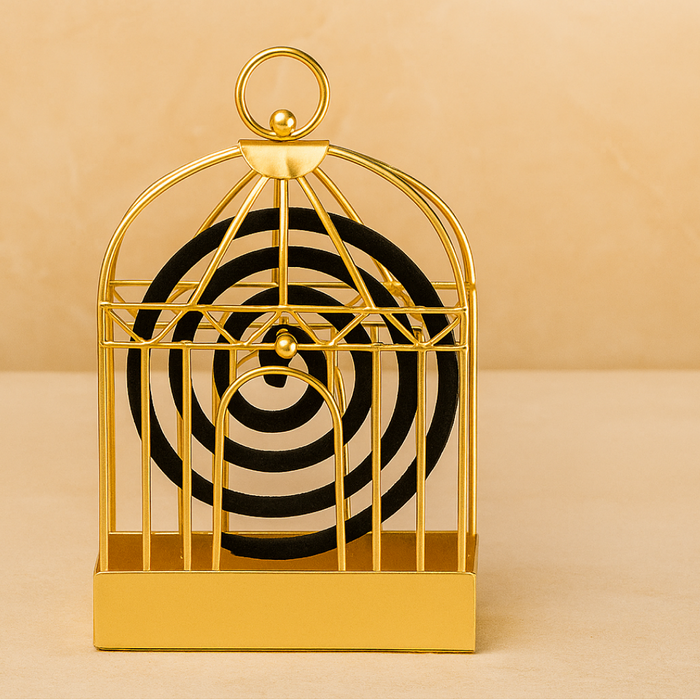 A gold metal birdcage-style holder with a black mosquito coil is centered against a warm beige background.