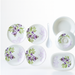 Full view of the 32-piece plastic tableware set, featuring plates, bowls, and serving dishes.