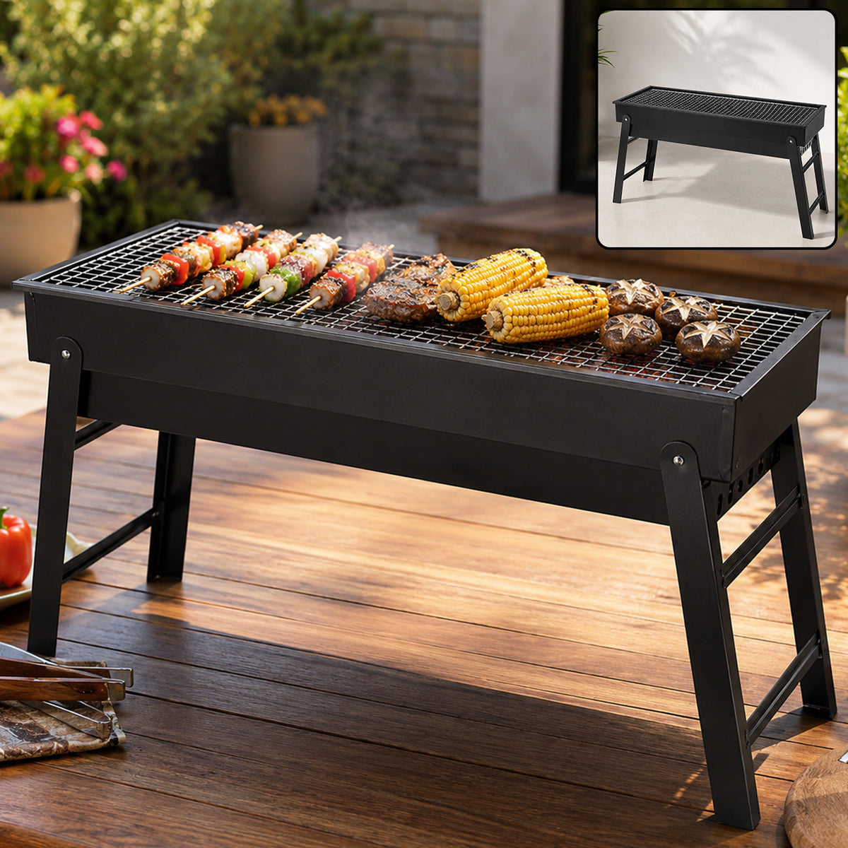 Black portable charcoal grill with food cooking on the grate, set outdoors on a wooden table.