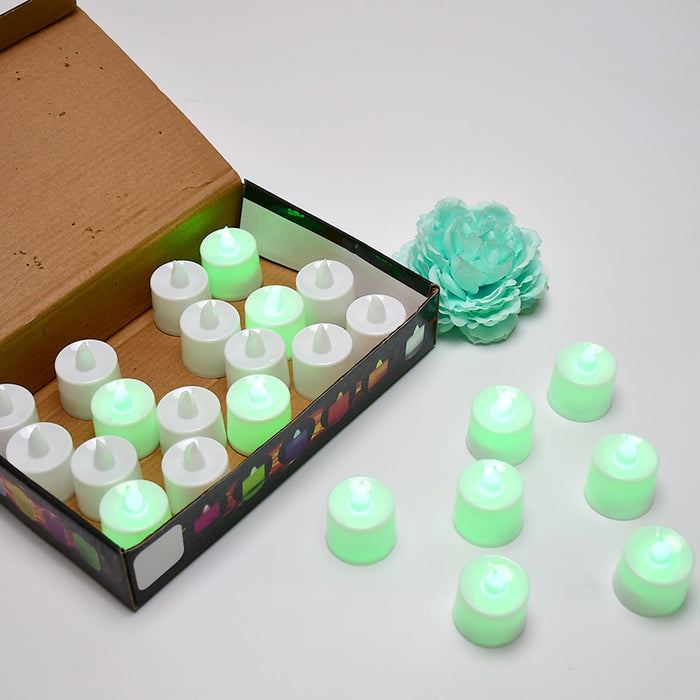 An open brown box contains twenty-four white flameless LED tealights, with several more glowing tealights on the white table.