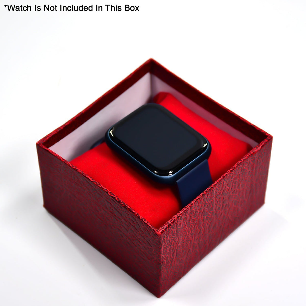 A dark blue smartwatch resting on a red velvet pillow inside an open red textured gift box.