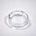 Clear glass ashtray featuring a classic round shape and convenient cigarette slots.