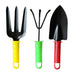 A yellow garden fork, green hand rake, and red trowel are arranged side-by-side on a white background.