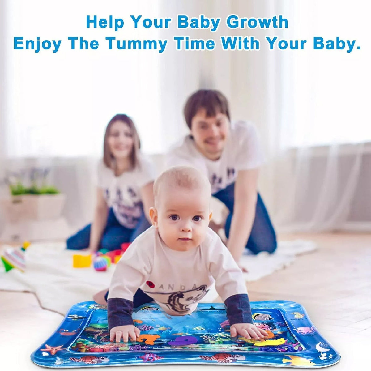 A baby on a blue water mat with parents kneeling in the background, encouraging tummy time.
