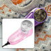 Pink corded lint remover in an inset, with a purple lint remover on a grey patterned sweater.