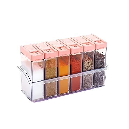 Six clear plastic spice jars with pink flip-top lids in a clear holder, filled with various spices on a white background.