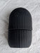 Black face ice roller placed on a textured grey cloth, showing its sleek design.