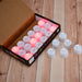 Vibrant red LED tealight candles, a pack of 24 for festive decorations.