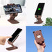 A four-panel image shows the brown bear phone stand holding a phone horizontally, charging, being touched, and held in a