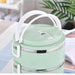 Four separate compartments in a stainless steel hot food tiffin.