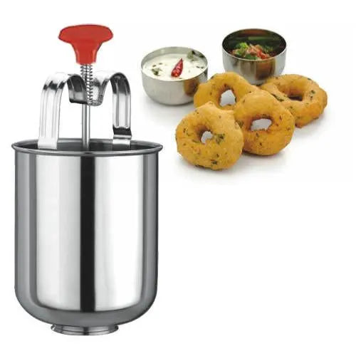A stainless steel medu vada maker with a red handle, four vadas, and two small bowls of sauce on a white background.