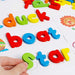 Colourful magnetic letters arranged on a whiteboard for alphabet learning.