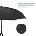 A close-up of a black umbrella canopy covered in water droplets, highlighting its water-repellent surface.