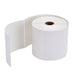 A roll of white thermal labels with a brown core, with a long section of blank labels unrolling to the left.