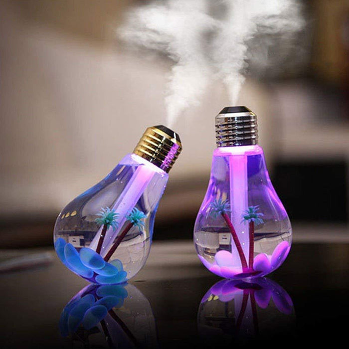 Two bulb-shaped humidifiers, one purple and one blue, emit mist with decorative palm trees inside.