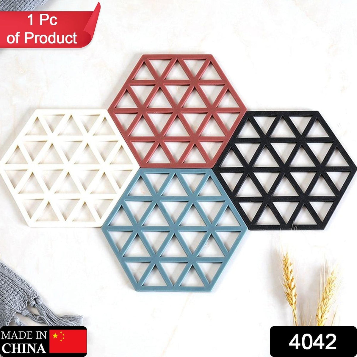Four hexagonal silicone coasters in white, maroon, blue, and black are arranged on a white surface.