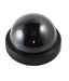 Black dome dummy security camera with a red light on a clean white background.