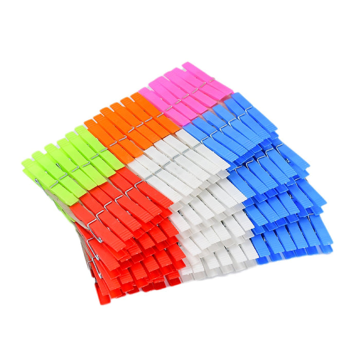 A large stack of colorful plastic clothes clips, arranged by color into blocks, on a white background.