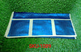 A dark blue refrigerator top cover with a subtle floral pattern and light yellow trim, folded on green artificial grass.