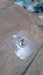 Simple wall hook with a clear adhesive base, ready for quick installation.
